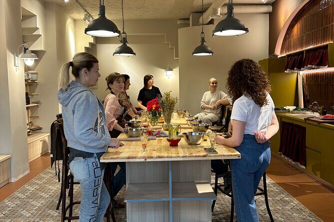 Traditional Albanian Cooking Class in Tirana with Raki Tasting - What the communal table does for the experience